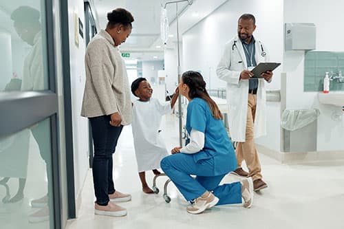 child and parent with doctors at hospital