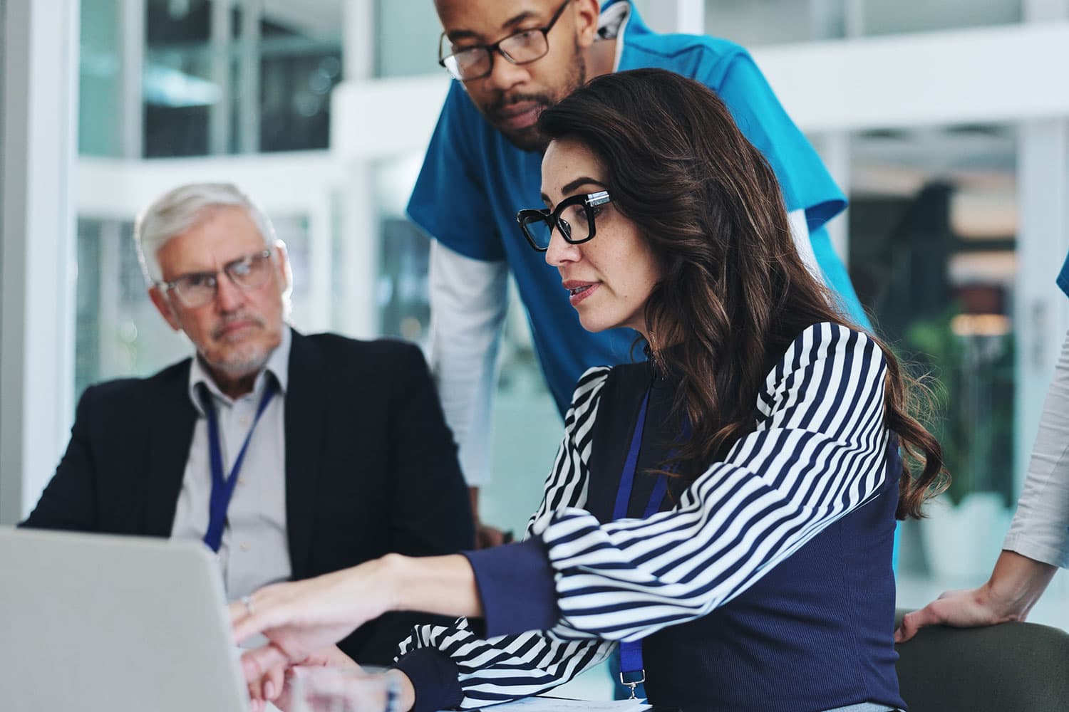 doctors in a group meeting looking at laptop