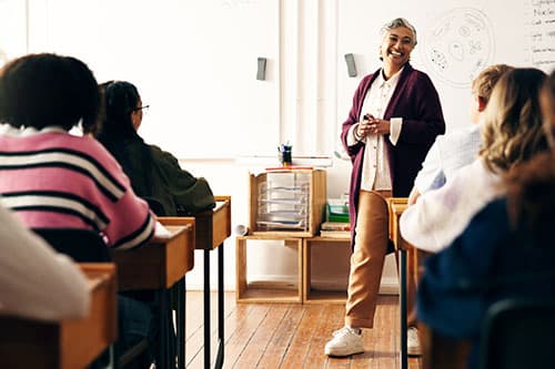 teens in a classroom with speaker presenting