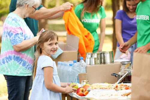 little girl getting food at Summerfest event