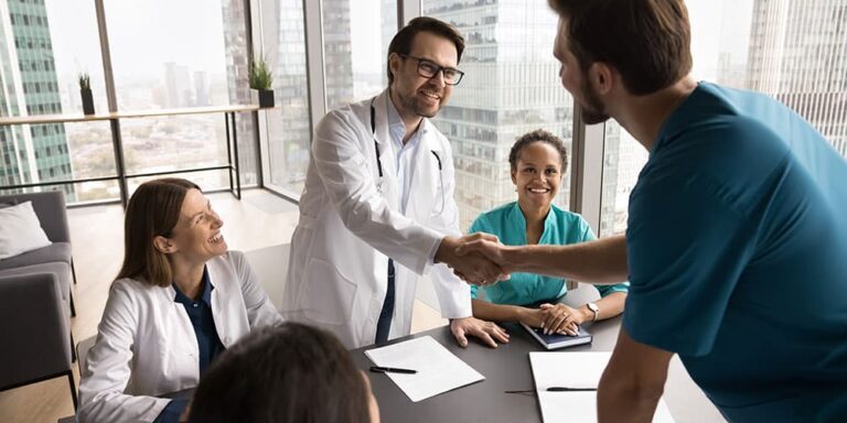 Doctors shaking hands in job interview